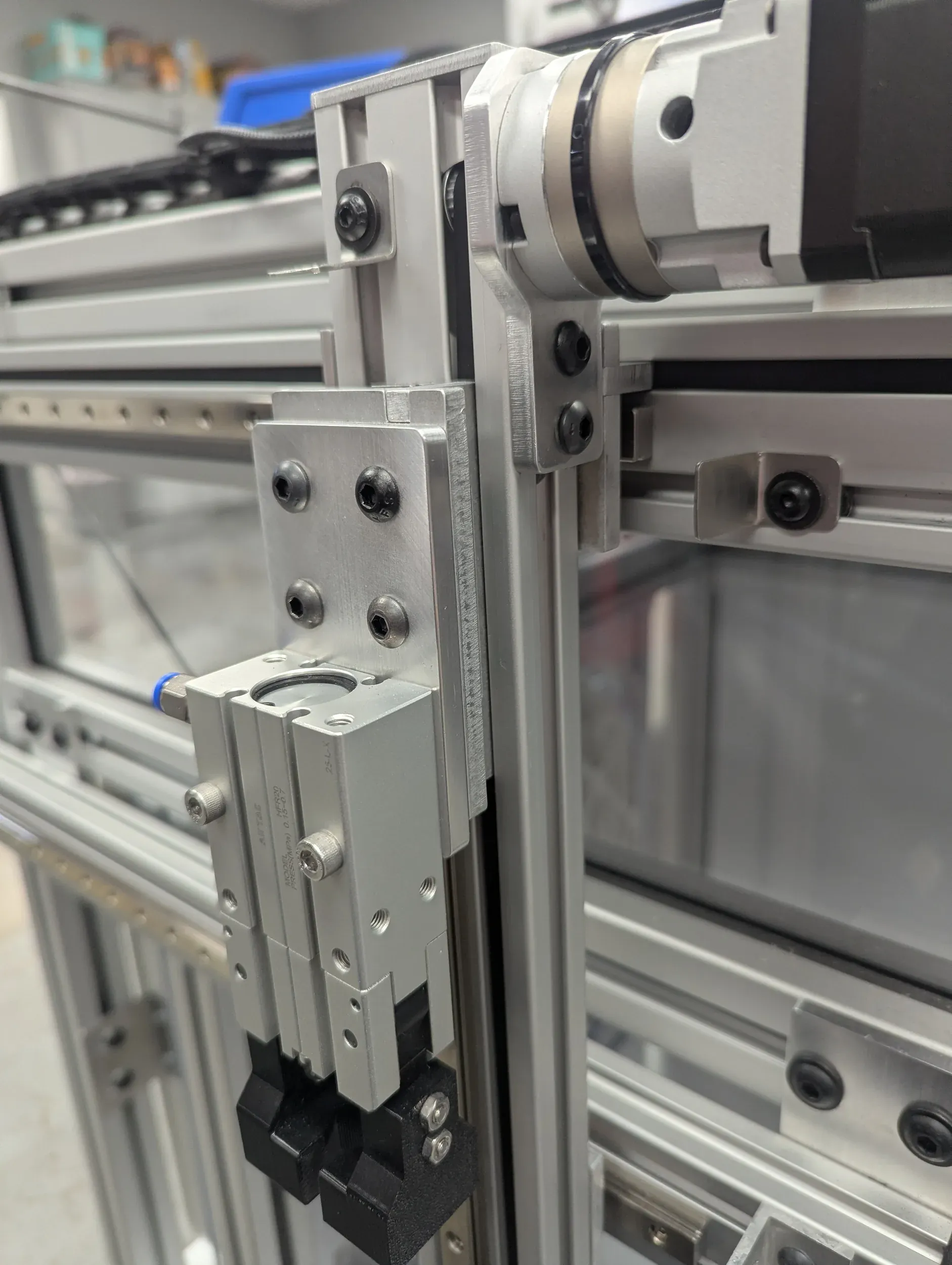 Vertical axis with a geared motor and pneumatic gripper on a custom T-slot machine